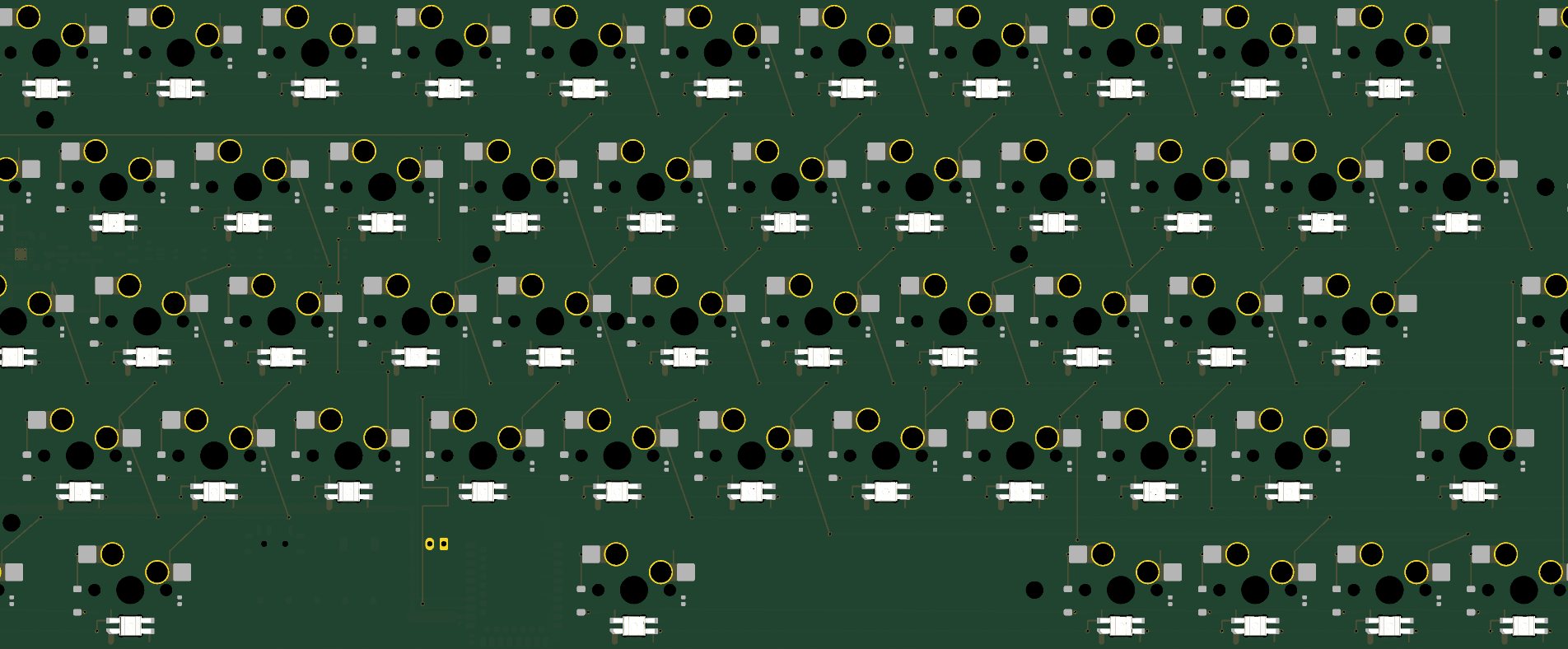 Part of the 65% board seen from above: rows of switch footprints and key lights, with the first traces between them
